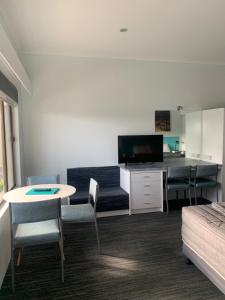 a living room with a couch and a table at Robetown Motel in Robe