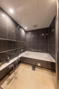 a large bathroom with a tub and a shower at Hotel Granbinario Tsuruga in Tsuruga