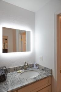 a bathroom with a sink and a mirror at South Maui 1 BR Guest Suite - Kamaole Beach Area in Wailea