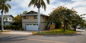a house with a palm tree in front of a street at South Maui 1 BR Guest Suite - Kamaole Beach Area in Wailea