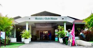 a woman sitting in front of a building at 316 Moonshine in Bridgetown