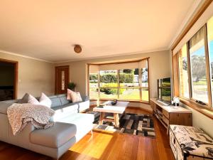 a living room with a couch and a table at The Hazards Beach Escape in Coles Bay