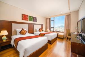 Postelja oz. postelje v sobi nastanitve Minh Toan Galaxy Hotel