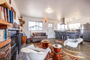 a living room with a couch and chairs and a kitchen at The Raven House - Renovated Homestead Cabin in Joshua Tree