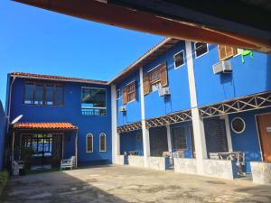 a blue building with the front of it at Pousada Beluga in Búzios