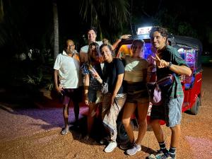 un grupo de personas de pie delante de un coche en Grand Refuge Romantic dinner & Bikes, en Anuradhapura