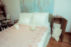 a bed with a striped comforter in a bedroom at Atelier for Artists in Bogotá