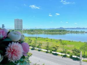 a view of a lake from a balcony with flowers at Annie House Hạ Long Bay in Ha Long