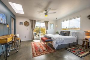 a bedroom with a bed and a desk and a desk at The Raven House - Renovated Homestead Cabin in Joshua Tree