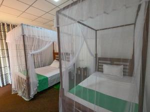 Postel nebo postele na pokoji v ubytování Wilpattu Mookalan Resort