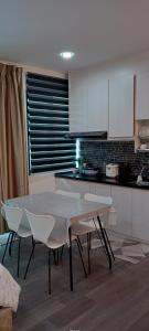 a kitchen with a table and chairs in a room at Melangok Homestay in Kajang