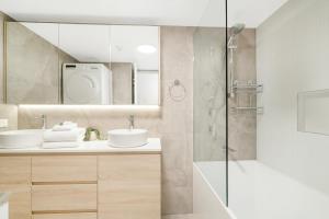 a bathroom with two sinks and a shower at Markham Court in Gold Coast