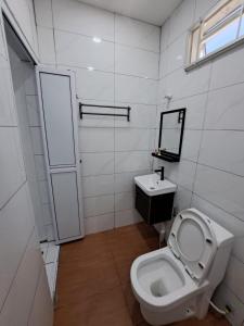 a bathroom with a toilet and a sink at Esah Best INN in Muar