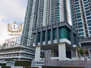 a tall building with a sign in front of it at Luxe Suites at Skyloft in Johor Bahru
