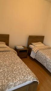 a room with two beds and a table at Apartmani Green Olive in Šušanj
