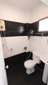 a bathroom with a toilet and a sink at Kings Auto Guesthouse in Hua Hin