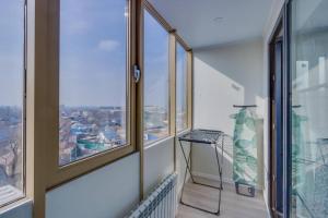 a balcony with a view of a city at Asaapart Ush-Sunkar 153 in Almaty