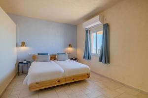 a bedroom with a large bed and a window at Shermans Hotel in Sede Boqer