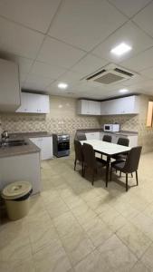 a kitchen with a table and chairs in a room at نماء الجود فرع الانصار in Al Madinah