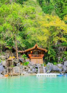 a house on the shore of a body of water at LIHIM RESORTS in El Nido