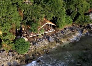 an aerial view of a house on the shore of a river at LIHIM RESORTS in El Nido