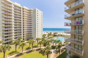 an aerial view of a building with palm trees and the ocean at Seaside Beach & Racquet 5614 in Romar Beach