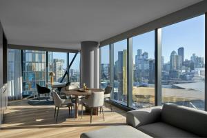 a living room with a view of a city at AC Hotel by Marriott Melbourne Southbank in Melbourne