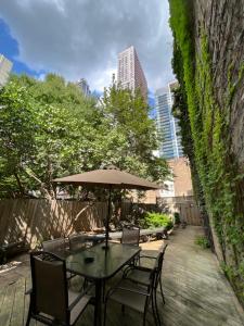 a table and chairs with an umbrella on a patio at 49 Hostel in Toronto