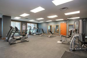 a gym with several treadmills and elliptical machines at Sutton Place Hotel Revelstoke Mountain Resort in Revelstoke +35 photos