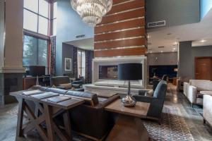 a living room with a couch and a fireplace at Sutton Place Hotel Revelstoke Mountain Resort in Revelstoke