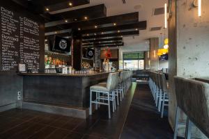 a bar with a row of chairs in a restaurant at Sutton Place Hotel Revelstoke Mountain Resort in Revelstoke