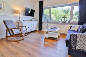 a living room with a couch and a table at Anker in Langeoog