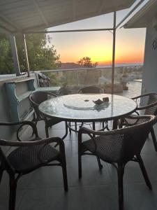 a table and chairs on a balcony with the sunset at ELRON - Golan Heights in Ani'am