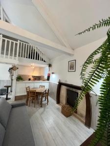 a living room with a couch and a table at Le moulin du château in Blain