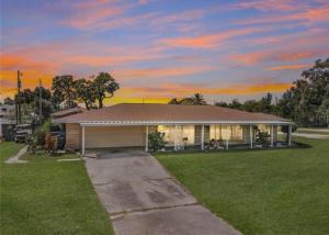 a house with a sunset in the background at Pool home on the Bay, large private yard near AMI in Bradenton