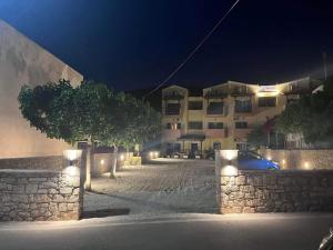a car parked in front of a building at night at STUDIOS ATHENA in Megalochori