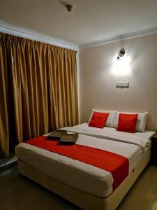 A bed or beds in a room at HOTEL PANTAI VIEW