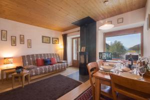 a living room with a couch and a table at Résidence Igloo 3 ski in-ski out - Happy Rentals in Le Tour