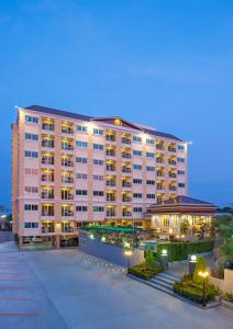 a large apartment building with a lit up building at ROYAL GRAND PATTAYA in Nong Prue