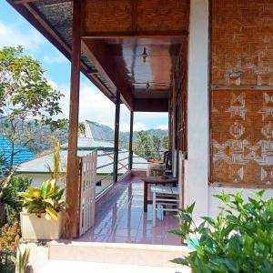 a balcony of a house with a view of the mountains at WATUGANA BUNGALOW KELIMUTU in Kelimutu