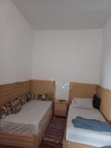a bedroom with two beds and a night stand at Kasba de l'artiste in Mirleft