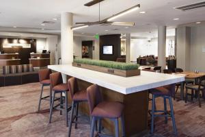 a large lobby with a bar with stools at Courtyard by Marriott Valdosta in Valdosta