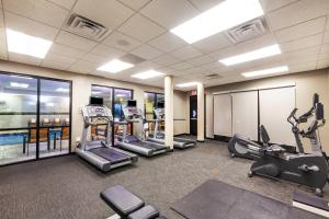 a gym with several treadmills and elliptical machines at Courtyard by Marriott Tulsa Woodland Hills in Tulsa