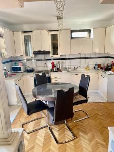 a kitchen with a table and chairs in it at Villa Magnifica in Strumica