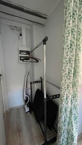 a room with a treadmill and a shower curtain at Apartament U Waldka in Mechelinki