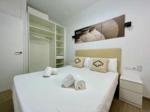 een slaapkamer met een wit bed met 2 kussens erop bij El Umbral de Muñices in Córdoba