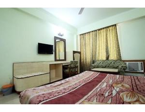 a hotel room with a large bed and a desk at Vishal Hotel, Katra in Katra