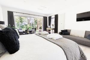 a bedroom with a large bed with pillows on it at Boswenna in St Ives