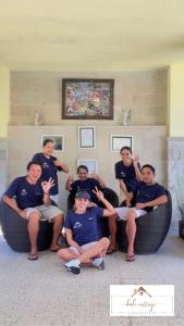 a group of people posing for a picture in a room at Bali Cottage Sambirenteng in Pabean Buleleng