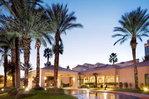 a building with palm trees in front of it at Courtyard by Marriott Las Vegas Convention Center in Las Vegas